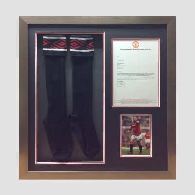 Sport socks framing with a diploma and a picture in Cardiff